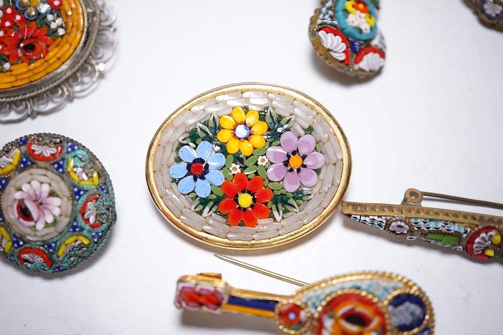 A collection of twenty-eight micro-mosaic brooches, including ten banjo and guitars shaped brooches, six similar large oval brooches, nine small brooches and three long brooches. (28) Condition - good